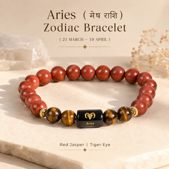 A beaded Aries Zodiac Bracelet made of polished red jasper and tiger eye, featuring a central black cube spacer with a gold Aries symbol. The bracelet is displayed on a light stone slab with decorative dried flowers and text overlays.