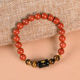 Aries Red Jasper and Tiger's Eye zodiac bracelet styled flat lay