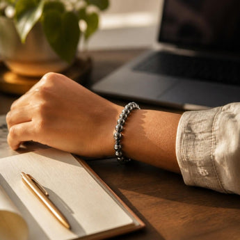Hematite bracelet worn on the wrist at a work desk