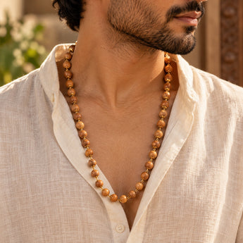 Devadaru Mala worn by a man over a linen shirt