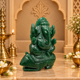 Jade Ganesh Ji murti in deep forest green on a marble altar with brass diya