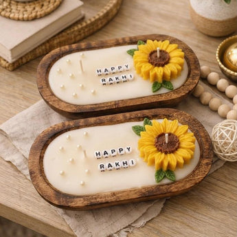 Happy Rakhi sunflower dough bowl candle — carved oval wooden bowl with sculpted wax sunflower, pearls and letter beads