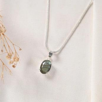 Natural labradorite pendant in silver prong setting on chain — front view showing blue flash