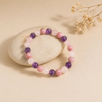Love and Stress Relief bracelet with rose quartz, amethyst and rhodochrosite beads on a cream pebble – World of Oorja