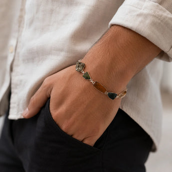 Hand wearing Raw Dhan Yog bracelet with natural uncut crystals - wealth attraction crystal bracelet