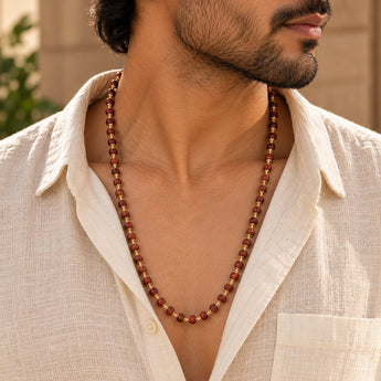 Red Sandalwood Mala worn by a man over a linen shirt