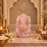 Rose Quartz Ganesh Ji murti in pale blush pink on a marble altar with brass diya