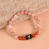 Taurus zodiac bracelet in Sunstone and Carnelian with engraved black onyx Taurus bead
