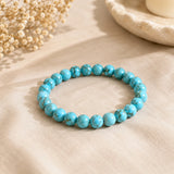 Turquoise Firoza bracelet with sky-blue beads and brown matrix veining on beige linen with dried baby breath – World of Oorja