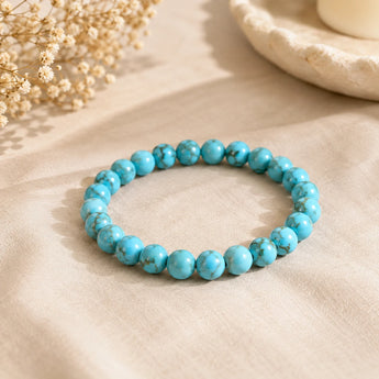 Turquoise Firoza bracelet with sky-blue beads and brown matrix veining on beige linen with dried baby breath – World of Oorja