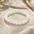 Milky Quartz bracelet with cloudy white crystal beads on beige linen - World of Oorja