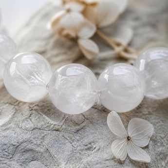 Close-up of natural Milky Quartz crystal beads showing cloudy white translucency - World of Oorja