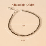 Pyrite adjustable anklet with measurement details on a beige background