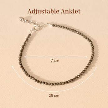 Pyrite adjustable anklet with measurement details on a beige background