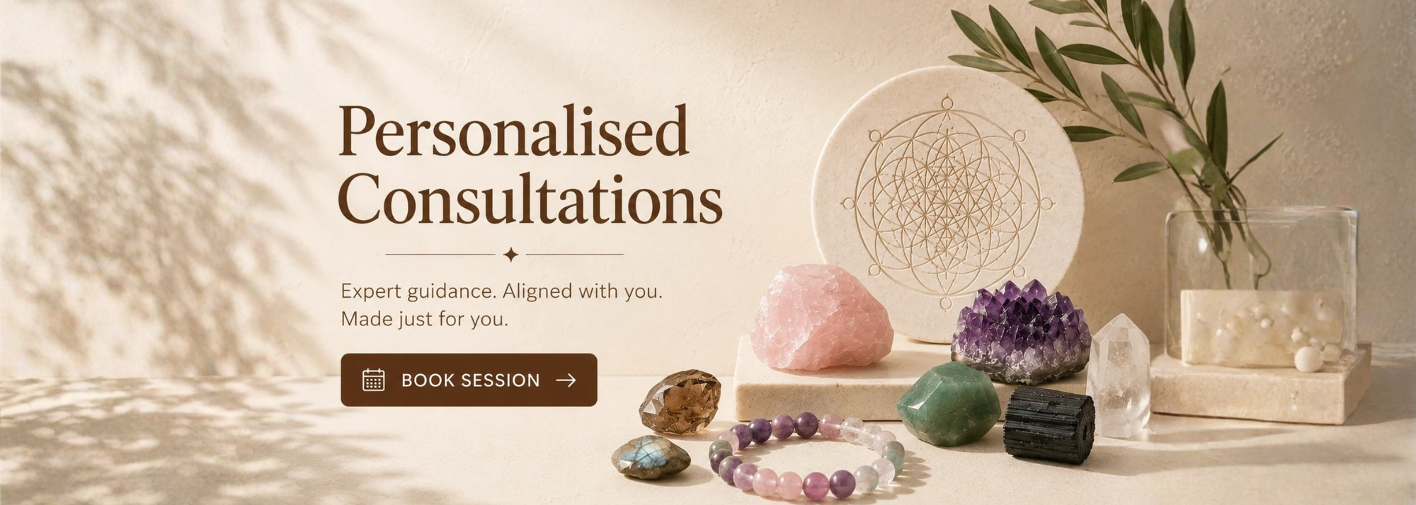 Promotional banner for personalized consultations featuring crystals, a dreamcatcher, and a glass vase with greenery on a warm beige background, with the text 'Personalised Consultations' and a 'BOOK SESSION' button.