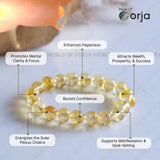 Yellow beaded bracelet with various benefits labeled on a light background, featuring the brand 'World of Orja'.
