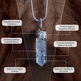 Crystal pendant necklace with labeled benefits on a wooden background