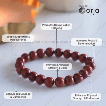 red beaded bracelet with various benefits listed on a light background, branded 'World of Orja'.