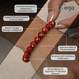Red beaded bracelet on wrist with health benefits text and 'World of Orja' branding.
