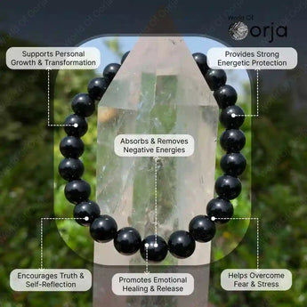 Black beaded bracelet with crystal in front, labeled benefits on a blurred natural background