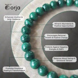 Green beaded bracelet on a wooden stand with Orja brand branding and benefits listed.