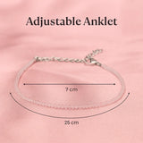 Adjustable rose quartz anklet with measurements on a pink background