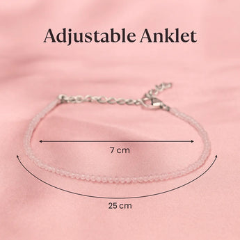 Adjustable rose quartz anklet with measurements on a pink background