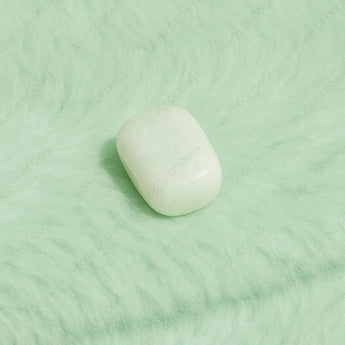 Tumble Light green stone on a textured green surface