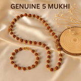 Genuine 5 Mukhi necklace and bracelet on a beige fabric background with dried flowers.