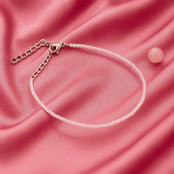 rose quartz anklet on a pink sating cloth 