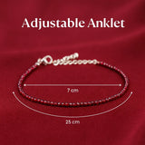 Garnet beaded anklet with adjustable chain on a red background