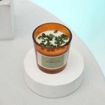 Crystal-infused candle with green aventurine for prosperity, growth, and balance