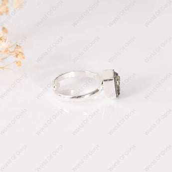 Silver ring with a large Pyrite Stone on a light gray background