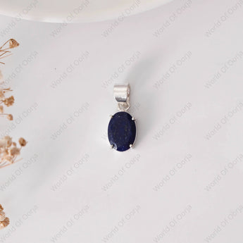 Silver pendant with a blue stone on a white background