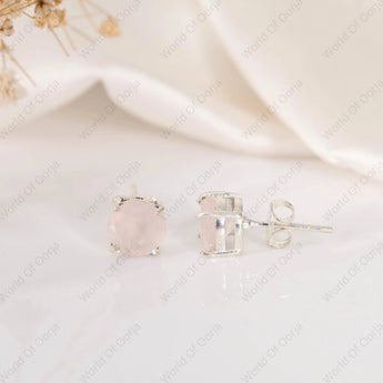 Silver stud earrings with a clear gemstone on a white background