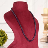 Necklace on a red mannequin bust with a blurred background