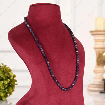 Necklace on a red mannequin bust with a blurred background