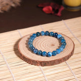 blue beaded bracelet on dark background 