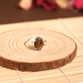 Ring with a large gemstone on a wooden surface