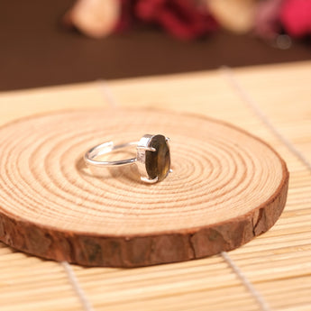 Labradorite Silver ring on a wooden surface with blurred background