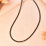 Black spinel beaded necklace on a light background
