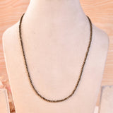 Pyrite diamond cut necklace on a light background