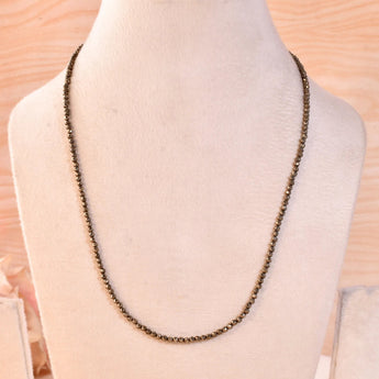 Pyrite diamond cut necklace on a light background