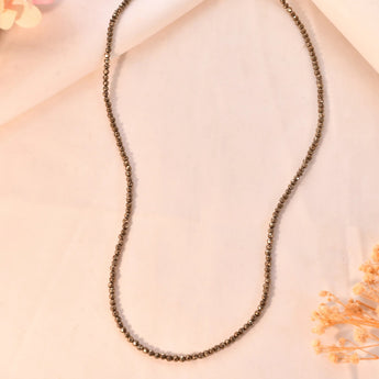 Pyrite diamond cut necklace on a light background