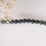Necklace with dark beads on a light background