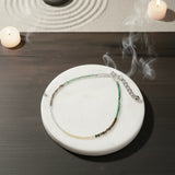 dhan yog anklet on a wooden table 