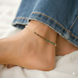 dhan yog Ankle bracelet on a person's ankle with denim jeans rolled up.