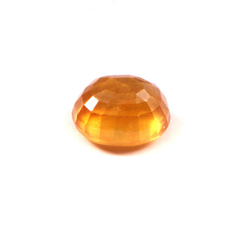 yellow sapphire (pukhraj) 8.92 carat stone on white background 