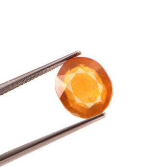 yellow sapphire (pukhraj) 8.92 carat stone on white background 