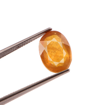 yellow sapphire (pukhraj) 7.22 carat stone on white background 
